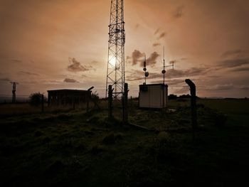 Silhouette plants on field against sky at sunset