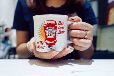 Close-up of hand holding coffee cup