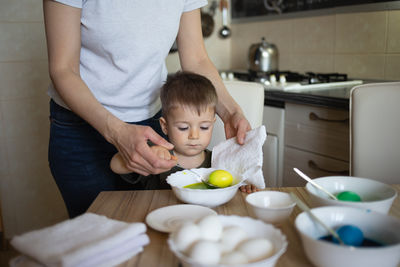 Midsection of woman holding food on table