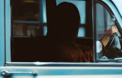 Woman looking through window