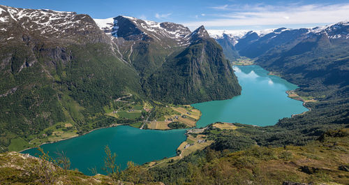 High angle view of lake and mountains against sky