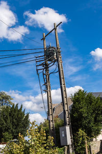 Low angle view of electricity pylon against sky