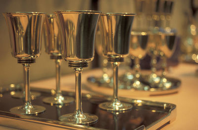 Close-up of wine glasses on table