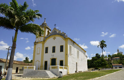 Built structure by building against blue sky