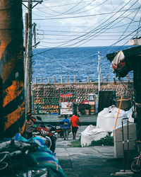 Rear view of people working at sea