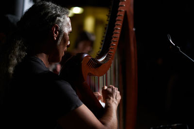 Midsection of man playing music concert