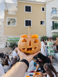 Close-up of man holding pumpkin