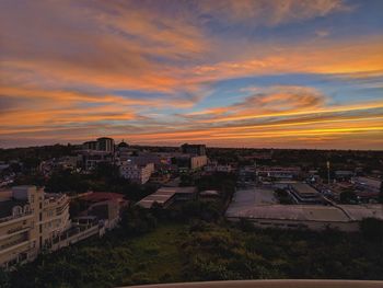 High angle view of townscape against orange sky