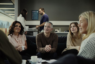 Group of business people having meeting in lobby