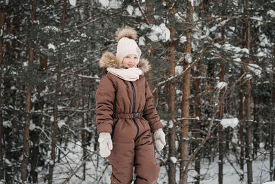 Girl in warm clothes in a winter forest. high quality photo