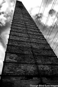 Low angle view of building against cloudy sky