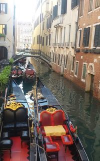 Boats in canal with buildings in background