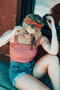 Portrait of young woman sitting outdoors