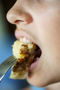 Close-up of young woman eating food