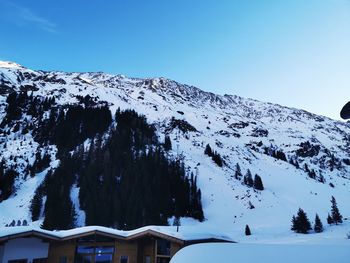 Scenic view of snowcapped mountains against clear sky