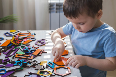 Mother playing with toy blocks at home