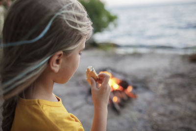 Portrait of girl holding hands on beach