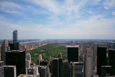 High angle view of cityscape and central park against sky