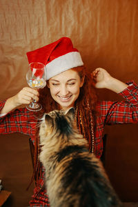 Portrait of smiling young woman in hat