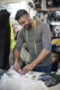 Tailor using pins in workshop