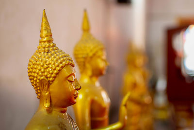 Close-up of statue against temple outside building