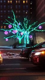 Illuminated city street at night