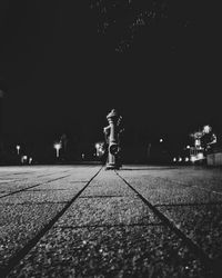 Man standing on footpath at night
