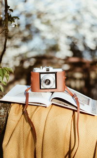 Vintage camera on book over rock