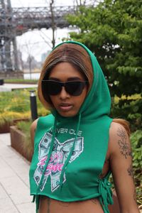 Portrait of young woman wearing sunglasses standing outdoors