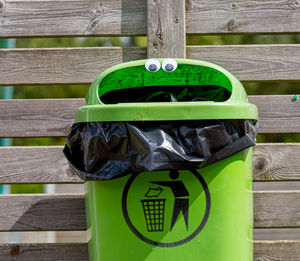 Close-up of garbage can against wall