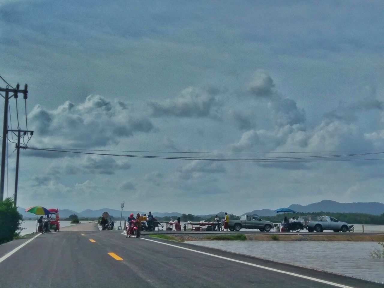 CARS ON STREET AGAINST SKY