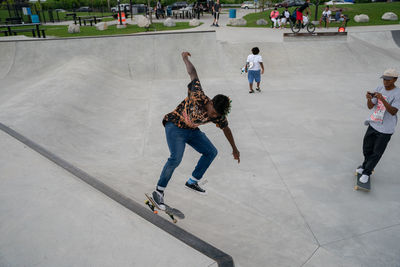 Rear view of people skateboarding