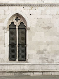 Low angle view of closed window on old building