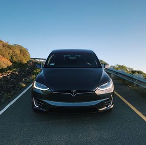 Close-up of car on road against clear blue sky