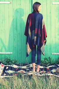 Full length of a young woman standing on tiled floor