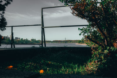 Scenic view of field by building against sky