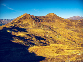 Scenic view of mountain range against blue sky