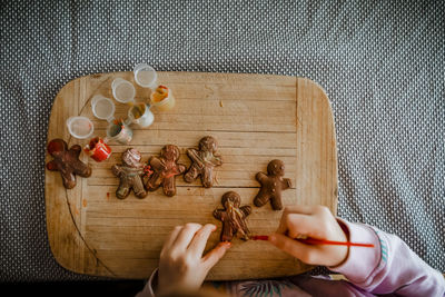 4 year old girl paints chocolate gingerbread men