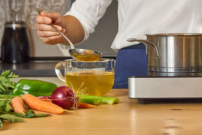 Midsection of man preparing food at home