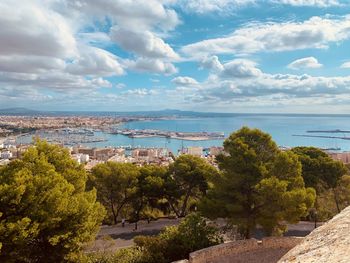 High angle view of townscape by sea against sky