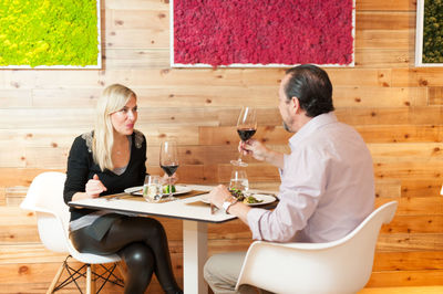 Mature couple having food and drink at restaurant