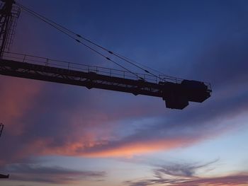 Low angle view of cables against sky during sunset