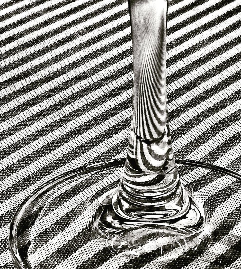 LOW SECTION OF MAN STANDING ON PATTERNED FLOOR