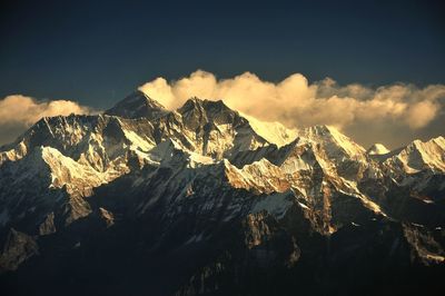 Scenic view of mountains against cloudy sky