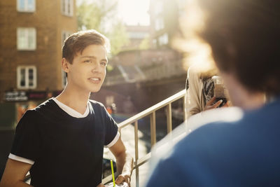 Young man standing in city