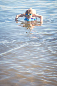 Portrait of boy playing in swimming pool