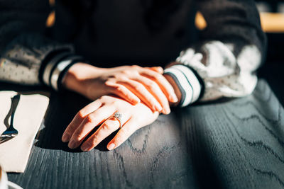 Midsection of woman on table