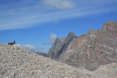 Scenic view of mountain range against blue sky