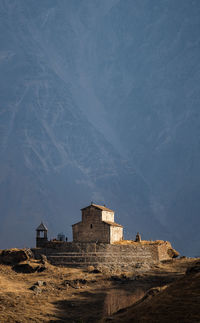 Buildings on mountain against sky