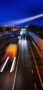 High angle view of light trails on highway at night